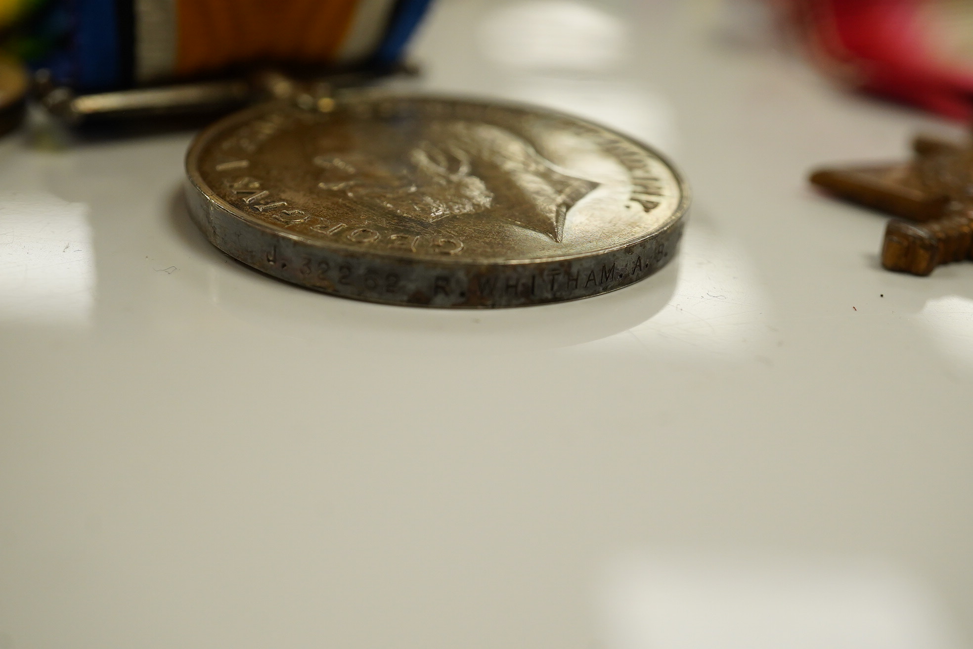 A WWI and WWII medal group awarded to R. Whitham A.B. R.N.; a First World War medal trio with a George V Long Service and Good Conduct Medal, together with a 1939-1945 Medal, the Atlantic Star, and the 1939-1945 Star. Co